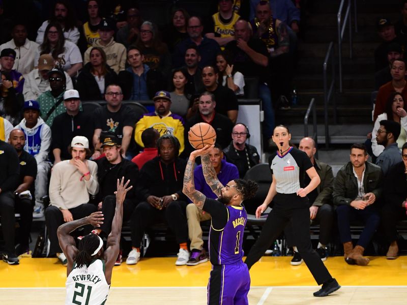 LOS ANGELES, CA - MARCH 8: D'Angelo Russell #1 of the Los Angeles Lakers shoots a three point basket against Patrick Beverley #21 of the Milwaukee Bucks during the game on March 8, 2024 at Crypto.Com Arena in Los Angeles, California. NOTE TO USER: User expressly acknowledges and agrees that, by downloading and/or using this Photograph, user is consenting to the terms and conditions of the Getty Images License Agreement. Mandatory Copyright Notice: Copyright 2024 NBAE (Photo by Adam Pantozzi/NBAE via Getty Images)