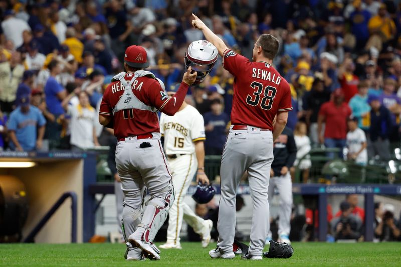 Oct 4, 2023; Milwaukee, Wisconsin, USA; Arizona Diamondbacks relief pitcher Paul Sewald (38) and catcher Jose Herrera (11) celebrate after winning against the Milwaukee Brewers in game two of the Wildcard series for the 2023 MLB playoffs at American Family Field. Mandatory Credit: Kamil Krzaczynski-USA TODAY Sports