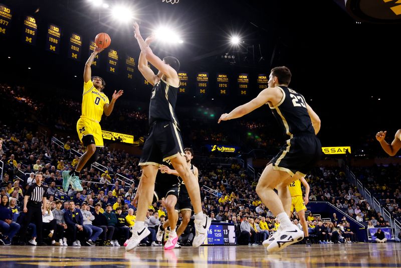 Feb 25, 2024; Ann Arbor, Michigan, USA;  Michigan Wolverines guard Dug McDaniel (0) shoots over Purdue Boilermakers center Zach Edey (15) in the first half at Crisler Center. Mandatory Credit: Rick Osentoski-USA TODAY Sports