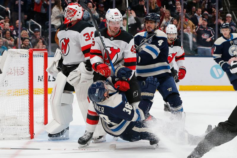 Dec 31, 2025; Columbus, Ohio, USA; New Jersey Devils defenseman Colton White (45) knocked Columbus Blue Jackets center Boone Jenner (38) to the ice during the second period at Nationwide Arena. Mandatory Credit: Russell LaBounty-Imagn Images