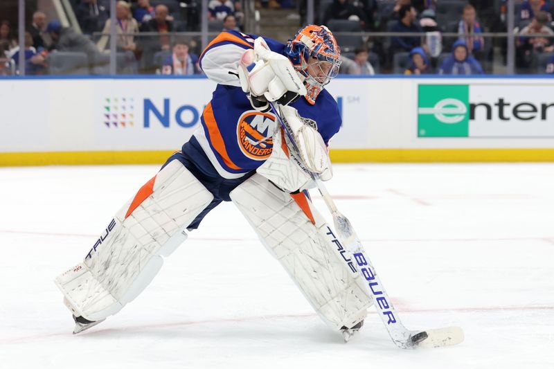 Oct 10, 2024; Elmont, New York, USA; New York Islanders goaltender Semyon Varlamov (40) plays the puck against the Utah Hockey Club during the third period at UBS Arena. Mandatory Credit: Brad Penner-Imagn Images