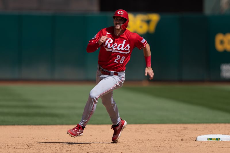 Apr 30, 2023; Oakland, California, USA;  Cincinnati Reds shortstop Kevin Newman (28) runs towards third base during the ninth inning against the Oakland Athletics at RingCentral Coliseum. Mandatory Credit: Stan Szeto-USA TODAY Sports