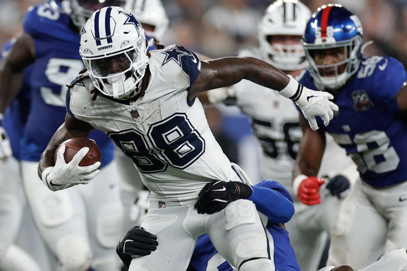 Dallas Cowboys wide receiver CeeDee Lamb (88) is tackled by New York Giants safety Jason Pinnock (27) during the first quarter of an NFL football game, Thursday, Sept. 26, 2024, in East Rutherford, N.J. (AP Photo/Adam Hunger)