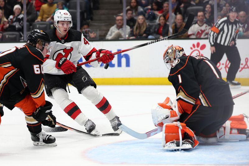 Mar 1, 2024; Anaheim, California, USA; New Jersey Devils defenseman Luke Hughes (43) attacks the goal against Anaheim Ducks goaltender Lukas Dostal (1) during the third period at Honda Center. Mandatory Credit: Kiyoshi Mio-USA TODAY Sports