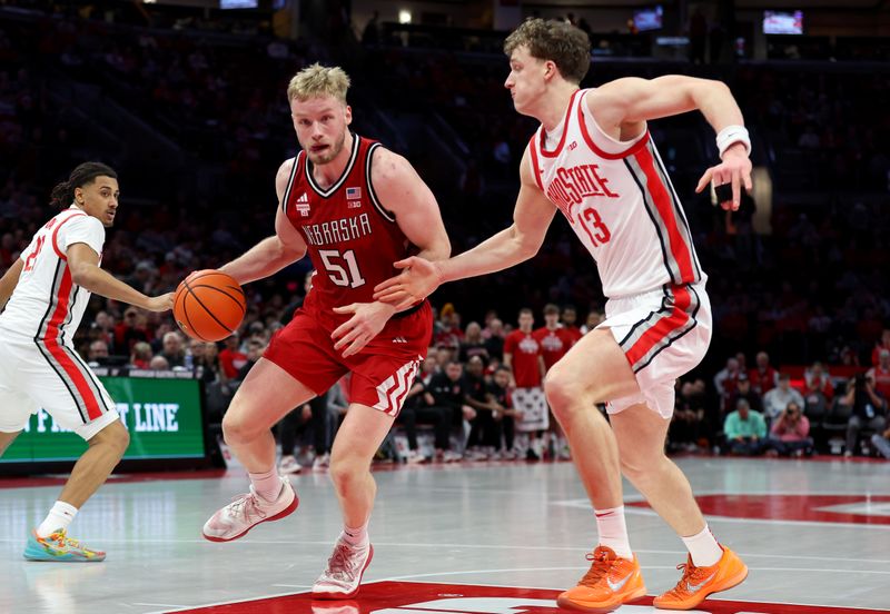 Jan 5, 2026; Columbus, Ohio, USA;  Nebraska Cornhuskers forward Rienk Mast (51) goes to the basket as Ohio State Buckeyes center Christoph Tilly (13) defends during the first half at Value City Arena. Mandatory Credit: Joseph Maiorana-Imagn Images