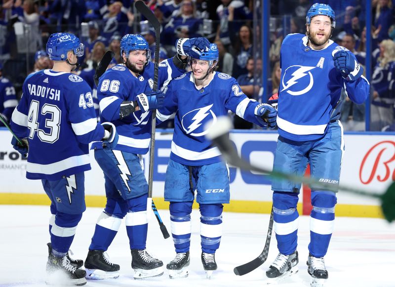 Jan 18, 2024; Tampa, Florida, USA; Tampa Bay Lightning center Brayden Point (21) is congratulated by defenseman Darren Raddysh (43), right wing Nikita Kucherov (86) and  defenseman Victor Hedman (77) after scoring a goal against the Minnesota Wild during the first period at Amalie Arena. Mandatory Credit: Kim Klement Neitzel-USA TODAY Sports