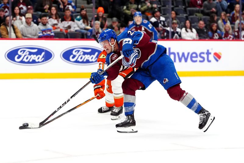 Oct 18, 2024; Denver, Colorado, USA; Colorado Avalanche right wing Logan O'Connor (25) shoots the puck past Anaheim Ducks defenseman Olen Zellweger (51) in overtime at Ball Arena. Mandatory Credit: Ron Chenoy-Imagn Images