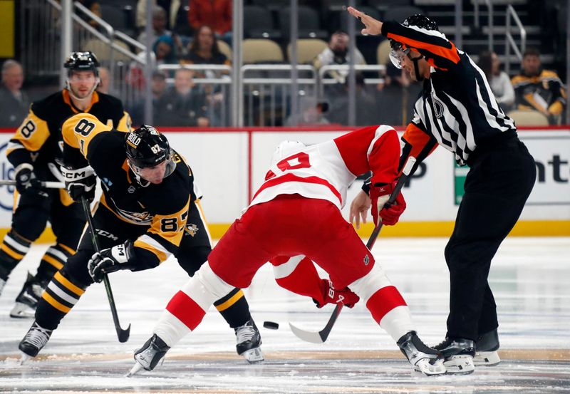 Oct 1, 2024; Pittsburgh, Pennsylvania, USA;  Pittsburgh Penguins center Sidney Crosby (87) and Detroit Red Wings center Joe Veleno (90) take the opening face-off during the first period at PPG Paints Arena. Mandatory Credit: Charles LeClaire-Imagn Images