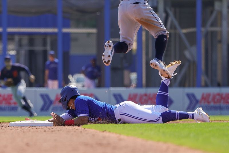 Feb 28, 2023; Dunedin, Florida, USA; Toronto Blue Jays second baseman Santiago Espinal (5) steals second base during the second inning against the Detroit Tigers at TD Ballpark. Mandatory Credit: Mike Watters-USA TODAY Sports