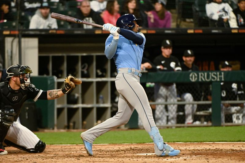 Apr 29, 2023; Chicago, Illinois, USA;  Tampa Bay Rays shortstop Wander Franco (5) hits a home run against the Chicago White Sox during the seventh inning at Guaranteed Rate Field. Mandatory Credit: Matt Marton-USA TODAY Sports