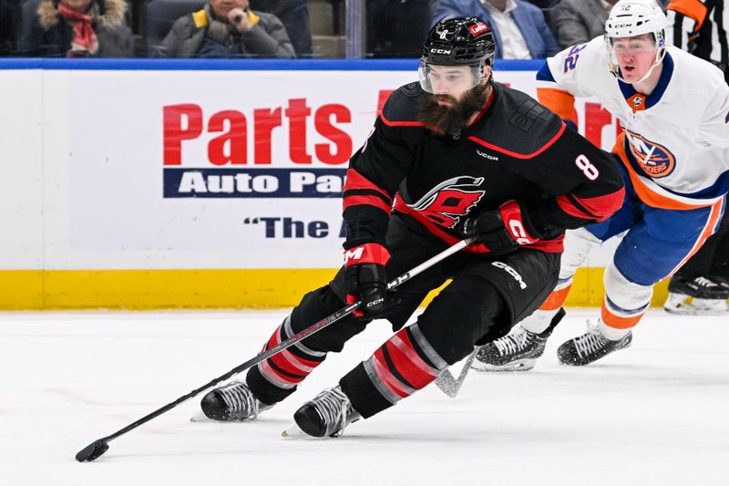 Mar 19, 2024; Elmont, New York, USA; Carolina Hurricanes defenseman Brent Burns (8) skates with the puck against the New York Islanders during the second period at UBS Arena. Mandatory Credit: Dennis Schneidler-USA TODAY Sports