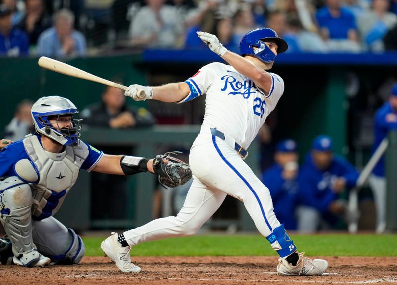 Apr 23, 2024; Kansas City, Missouri, USA; Kansas City Royals designated hitter Adam Frazier (26) hits a double against the Toronto Blue Jays during the fifth inning at Kauffman Stadium. Mandatory Credit: Jay Biggerstaff-USA TODAY Sports