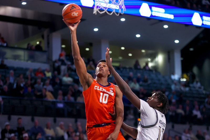 Feb 21, 2024; Atlanta, Georgia, USA; Clemson Tigers forward RJ Godfrey (10) shoots past Georgia Tech Yellow Jackets forward Baye Ndongo (11) in the first half at McCamish Pavilion. Mandatory Credit: Brett Davis-USA TODAY Sports