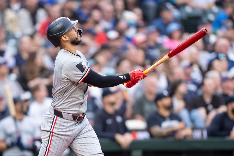 Jun 28, 2024; Seattle, Washington, USA; Minnesota Twins shortstop Carlos Correa (4) hits a two-run home run during the sixth inning against the Seattle Mariners at T-Mobile Park. Mandatory Credit: Stephen Brashear-USA TODAY Sports