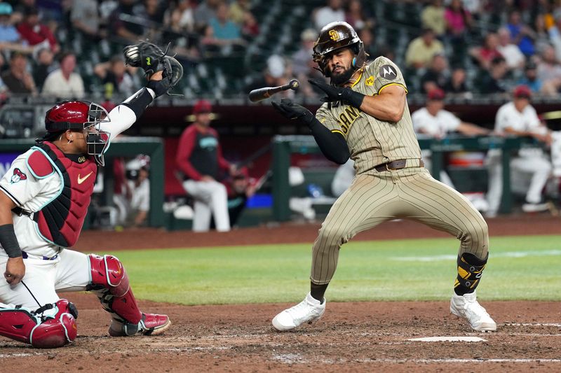 May 3, 2024; Phoenix, Arizona, USA; San Diego Padres outfielder Fernando Tatis Jr. (23) dodges a pitch against the Arizona Diamondbacks during the ninth inning at Chase Field. Mandatory Credit: Joe Camporeale-USA TODAY Sports