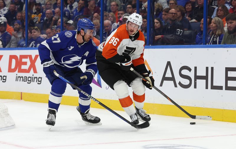 Nov 7, 2024; Tampa, Florida, USA; Philadelphia Flyers left wing Joel Farabee (86) skates with the puck as Tampa Bay Lightning defenseman Ryan McDonagh (27) defends during the second period at Amalie Arena. Mandatory Credit: Kim Klement Neitzel-Imagn Images