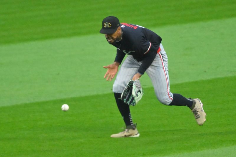 May 18, 2024; Cleveland, Ohio, USA; Minnesota Twins center fielder Byron Buxton (25) reaches for the ball on a base hit by the Cleveland Guardians in the seventh inning at Progressive Field. Mandatory Credit: David Richard-USA TODAY Sports