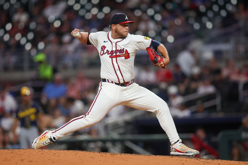 Aug 6, 2024; Atlanta, Georgia, USA; Atlanta Braves relief pitcher Joe Jimenez (77) throws against the Milwaukee Brewers in the eighth inning at Truist Park. Mandatory Credit: Brett Davis-USA TODAY Sports
