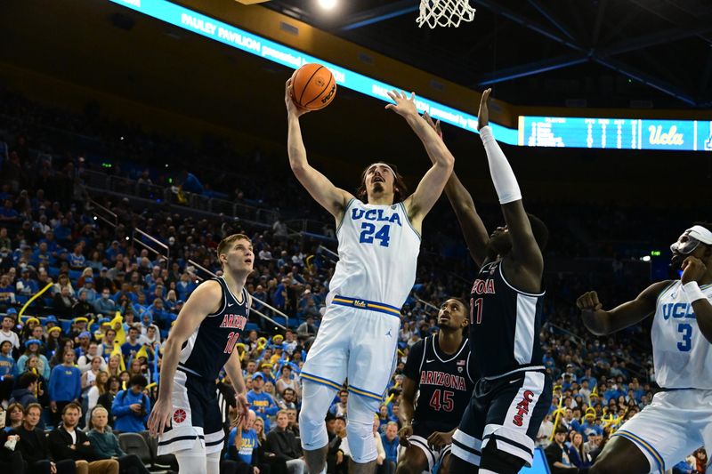 Mar 4, 2023; Los Angeles, California, USA;  UCLA Bruins guard Jaime Jaquez Jr. (24) drives to the basket as Arizona Wildcats center Oumar Ballo (11) defends during the second half at Pauley Pavilion presented by Wescom. Mandatory Credit: Richard Mackson-USA TODAY Sports