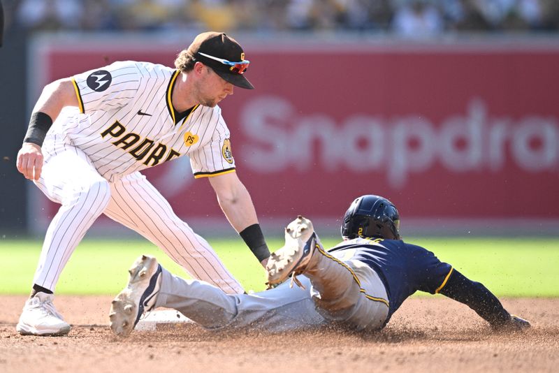 Jun 22, 2024; San Diego, California, USA; Milwaukee Brewers second baseman Brice Turang (2) is caught stealing second base by San Diego Padres second baseman Jake Cronenworth (9) during the third inning at Petco Park. Mandatory Credit: Orlando Ramirez-USA TODAY Sports