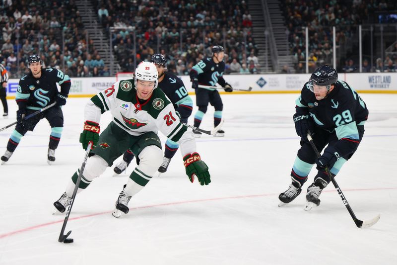 Dec 10, 2023; Seattle, Washington, USA; Minnesota Wild right wing Brandon Duhaime (21) advances the puck while defended by Seattle Kraken defenseman Vince Dunn (29) during the first period at Climate Pledge Arena. Mandatory Credit: Steven Bisig-USA TODAY Sports