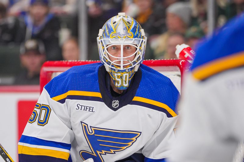 Nov 28, 2023; Saint Paul, Minnesota, USA; St. Louis Blues goaltender Jordan Binnington (50) watches the puck against the Minnesota Wild in the second period at Xcel Energy Center. Mandatory Credit: Brad Rempel-USA TODAY Sports