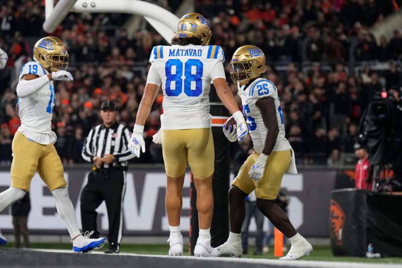 Oct 14, 2023; Corvallis, Oregon, USA; UCLA Bruins running back TJ Harden (25) celebrates with teammates after scoring a touchdown during the second half against the Oregon State Beavers at Reser Stadium. Mandatory Credit: Soobum Im-USA TODAY Sports