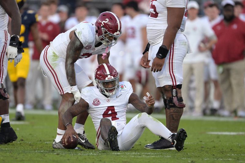 Jan 1, 2024; Pasadena, CA, USA; Alabama Crimson Tide quarterback Jalen Milroe (4) is helped up by running back Jase McClellan (2) during the second half against the Michigan Wolverines in the 2024 Rose Bowl college football playoff semifinal game at Rose Bowl. Mandatory Credit: Jayne Kamin-Oncea-USA TODAY Sports