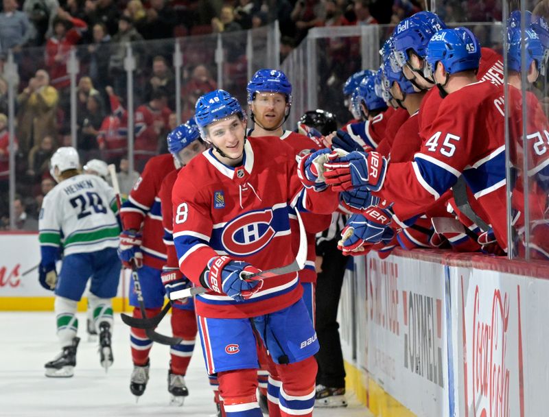 Jan 6, 2025; Montreal, Quebec, CAN; Montreal Canadiens defenseman Lane Hutson (48) celebrates with teammates after scoring a goal against the Vancouver Canucks during the third period at the Bell Centre. Mandatory Credit: Eric Bolte-Imagn Images