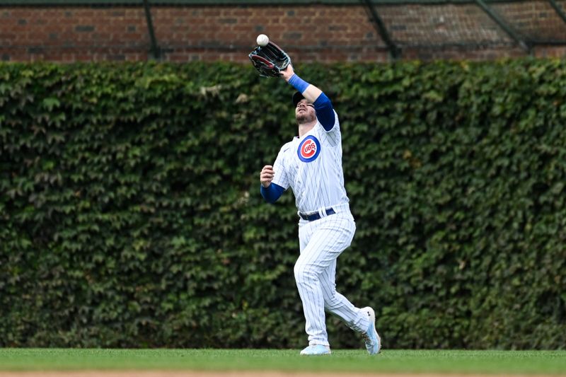 Sep 24, 2023; Chicago, Illinois, USA;  Chicago Cubs left fielder Ian Happ (8) catches a fly ball hit by Colorado Rockies third baseman Elehuris Montero (44) during the sixth inning at Wrigley Field. Mandatory Credit: Matt Marton-USA TODAY Sports