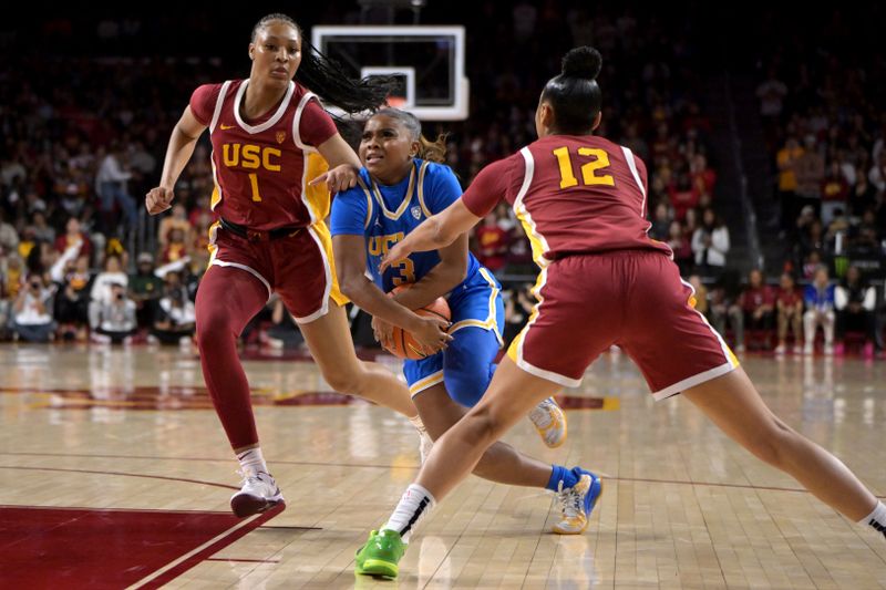 Jan 14, 2024; Los Angeles, California, USA; USC Trojans guard Taylor Bigby (1) defends UCLA Bruins guard Londynn Jones (3) and USC Trojans guard JuJu Watkins (12) knocks the ball loose in the first half at Galen Center. Mandatory Credit: Jayne Kamin-Oncea-USA TODAY Sports