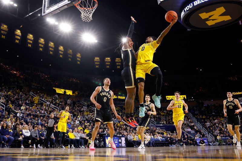 Feb 25, 2024; Ann Arbor, Michigan, USA;  Michigan Wolverines guard Dug McDaniel (0) shoots on Purdue Boilermakers guard Lance Jones (55) in the first half at Crisler Center. Mandatory Credit: Rick Osentoski-USA TODAY Sports