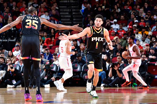 HOUSTON, TX - DECEMBER 27:   Devin Booker #1 and Kevin Durant #35 of the Phoenix Suns high five during the game against the Houston Rockets on December 27, 2023 at the Toyota Center in Houston, Texas. NOTE TO USER: User expressly acknowledges and agrees that, by downloading and or using this photograph, User is consenting to the terms and conditions of the Getty Images License Agreement. Mandatory Copyright Notice: Copyright 2023 NBAE (Photo by Logan Riely/NBAE via Getty Images)