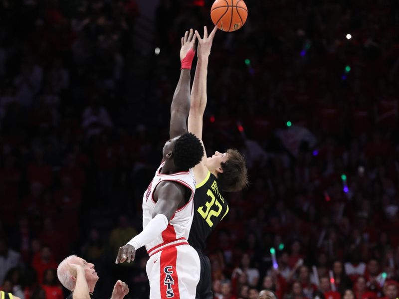 Feb 2, 2023; Tucson, Arizona, USA;Arizona Wildcats center Oumar Ballo (11) and Oregon Ducks center Nate Bittle (32) tip of in the first half at McKale Center. Mandatory Credit: Zachary BonDurant-USA TODAY Sports