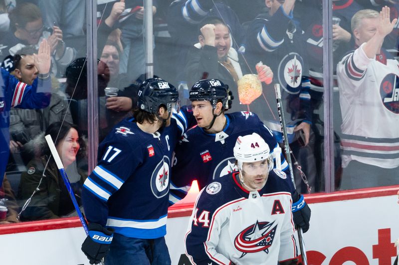 Jan 9, 2024; Winnipeg, Manitoba, CAN; Winnipeg Jets forward Gabriel Vilardi (13) celebrates with forward Adam Lowry (17) after scoring a goal against the Columbus Blue Jackets during the third period at Canada Life Centre. Mandatory Credit: Terrence Lee-USA TODAY Sports