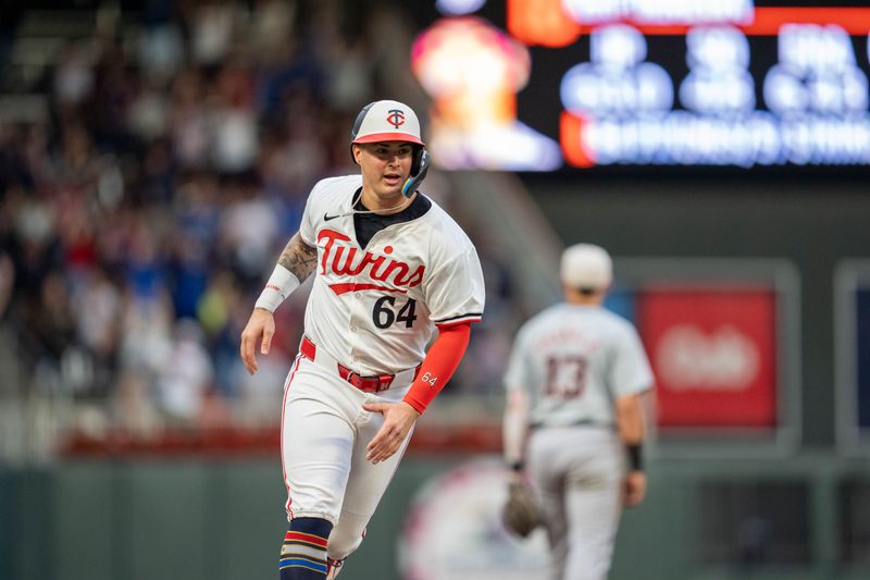 Jul 4, 2024; Minneapolis, Minnesota, USA; Minnesota Twins third base Jose Miranda (64) heads home after catcher Ryan Jeffers (27) hit a home run against the Detroit Tigers in the fourth inning at Target Field. Mandatory Credit: Matt Blewett-USA TODAY Sports