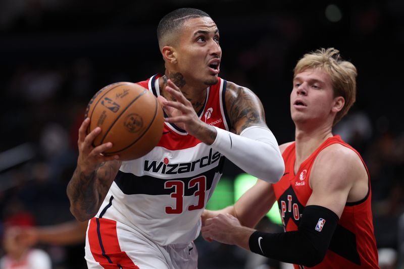 WASHINGTON, DC - OCTOBER 11: Kyle Kuzma #33 of the Washington Wizards dribbles against the Toronto Raptors during the first half of a preseason game at Capital One Arena on October 11, 2024 in Washington, DC. NOTE TO USER: User expressly acknowledges and agrees that, by downloading and or using this photograph, User is consenting to the terms and conditions of the Getty Images License Agreement. (Photo by Patrick Smith/Getty Images)