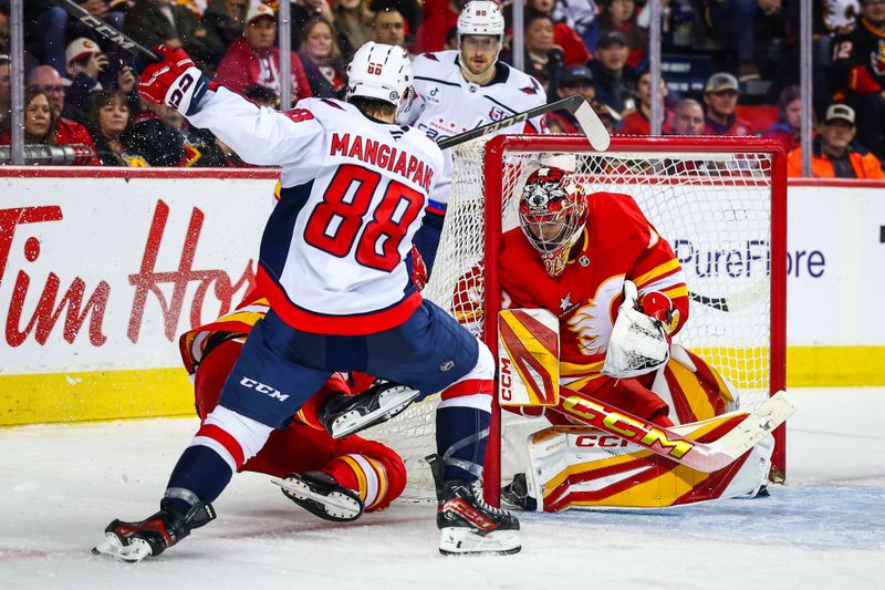 Jan 28, 2025; Calgary, Alberta, CAN; Calgary Flames goaltender Dustin Wolf (32) makes a save against Washington Capitals left wing Andrew Mangiapane (88) during the third period at Scotiabank Saddledome. Mandatory Credit: Sergei Belski-Imagn Images