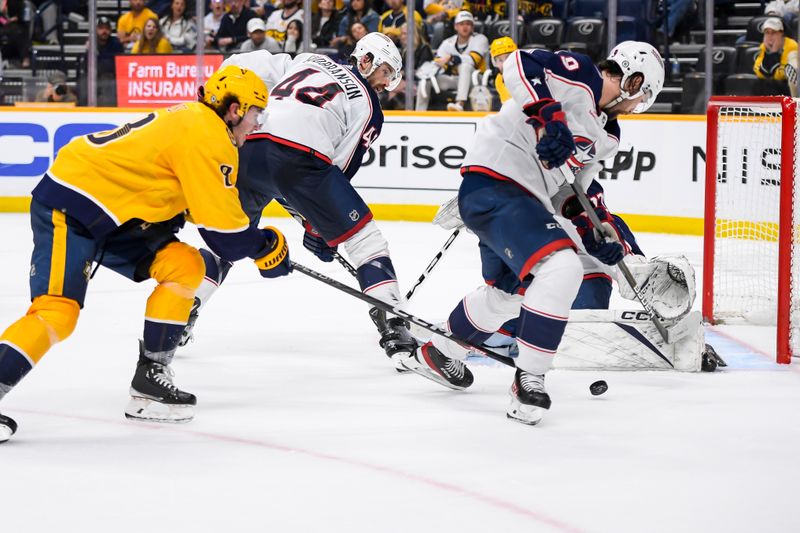 Apr 13, 2024; Nashville, Tennessee, USA; Nashville Predators center Cody Glass (8) pokes the puck between the legs of Columbus Blue Jackets defenseman Ivan Provorov (9) during the third period at Bridgestone Arena. Mandatory Credit: Steve Roberts-USA TODAY Sports