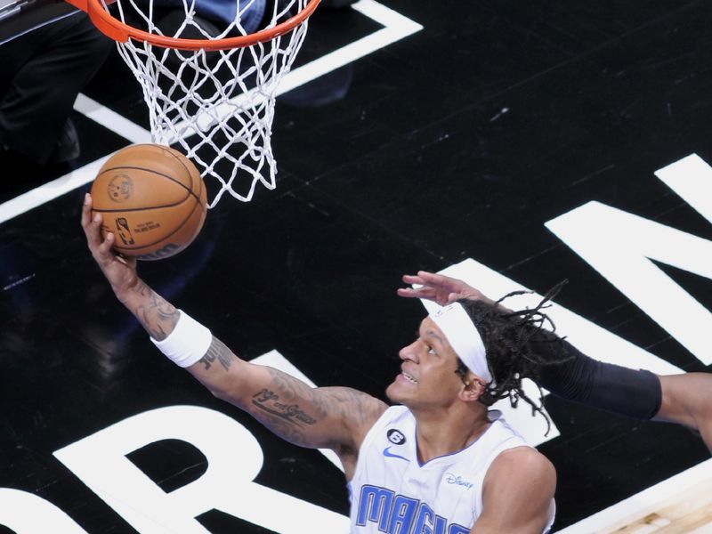 ORLANDO, FL - JANUARY 25: Paolo Banchero #5 of the Orlando Magic goes to the basket against the Indiana Pacers on January 25, 2023 at Amway Center in Orlando, Florida. NOTE TO USER: User expressly acknowledges and agrees that, by downloading and or using this photograph, User is consenting to the terms and conditions of the Getty Images License Agreement. Mandatory Copyright Notice: Copyright 2023 NBAE (Photo by Fernando Medina/NBAE via Getty Images)