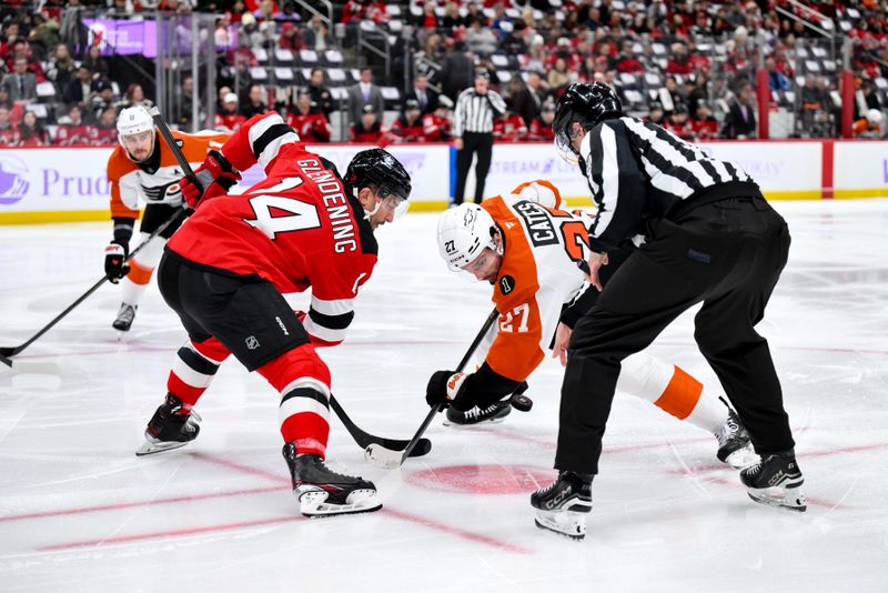 Nov 29, 2025; Newark, New Jersey, USA; New Jersey Devils center Luke Glendening (14) faces off against Philadelphia Flyers left wing Noah Cates (27) during the first period at Prudential Center. Mandatory Credit: John Jones-Imagn Images