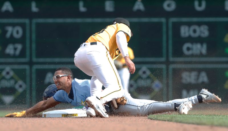 Jun 22, 2024; Pittsburgh, Pennsylvania, USA;  Tampa Bay Rays second baseman Richie Palacios (left) steals second base as Pittsburgh Pirates second baseman Nick Gonzales (39) applies alate tag during the fourth inning at PNC Park. Mandatory Credit: Charles LeClaire-USA TODAY Sports