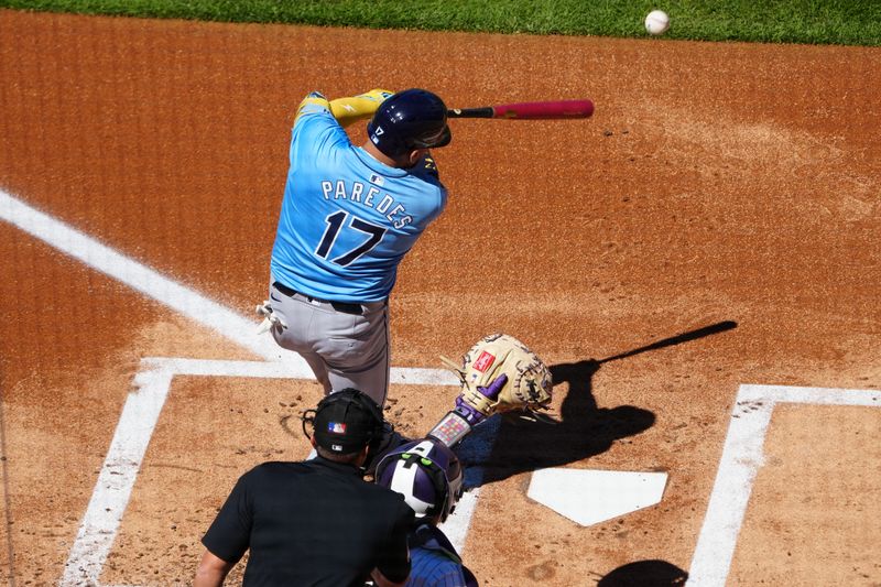 Apr 5, 2024; Denver, Colorado, USA; Tampa Bay Rays third base Isaac Paredes (17) hits an RBI single in the first inning against the Colorado Rockies at Coors Field. Mandatory Credit: Ron Chenoy-USA TODAY Sports