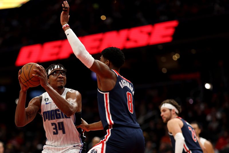 WASHINGTON, DC - JANUARY 21: Wendell Carter Jr. #34 of the Orlando Magic dribbles in front of Rui Hachimura #8 of the Washington Wizards during the first half at Capital One Arena on January 21, 2023 in Washington, DC. NOTE TO USER: User expressly acknowledges and agrees that, by downloading and or using this photograph, User is consenting to the terms and conditions of the Getty Images License Agreement. (Photo by Patrick Smith/Getty Images)