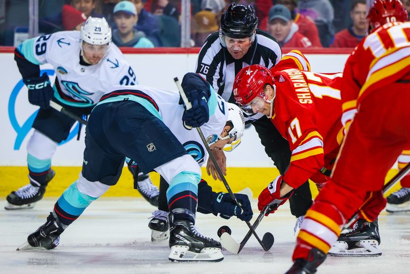 Mar 4, 2024; Calgary, Alberta, CAN; Calgary Flames center Yegor Sharangovich (17) and Seattle Kraken center Yanni Gourde (37) face off for the puck during the second period at Scotiabank Saddledome. Mandatory Credit: Sergei Belski-USA TODAY Sports