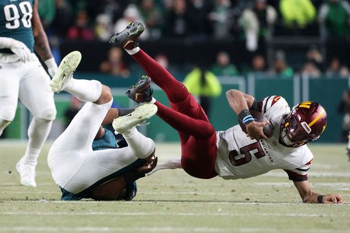 Philadelphia Eagles linebacker Nolan Smith Jr. (3) takes down Washington Commanders quarterback Jayden Daniels (5) during the NFC Championship NFL football game, Sunday, Jan. 26, 2025, in Philadelphia. (AP Photo/Daniel Kucin Jr.)