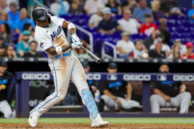 Sep 24, 2023; Miami, Florida, USA; Miami Marlins designated hitter Jorge Soler (12) hits a single against the Milwaukee Brewers during the eighth inning at loanDepot Park. Mandatory Credit: Sam Navarro-USA TODAY Sports