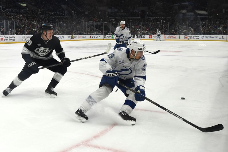 Jan 1, 2026; Los Angeles, California, USA; Tampa Bay Lightning right wing Pontus Holmberg (29) and Los Angeles Kings center Samuel Helenius (79) battle for the puck during the third period at Crypto.com Arena. Mandatory Credit: Griffin Hooper-Imagn Images