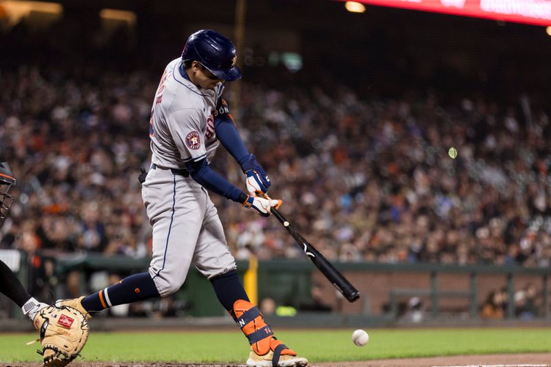 Jun 10, 2024; San Francisco, California, USA; Houston Astros left fielder Mauricio Dubón (14) grounds a single against the San Francisco Giants during the ninth inning at Oracle Park. Mandatory Credit: John Hefti-USA TODAY Sports