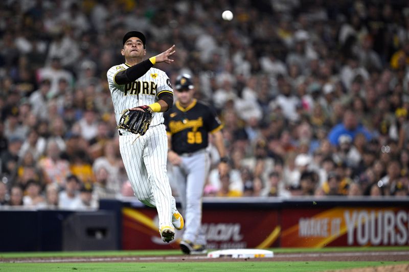 Aug 12, 2024; San Diego, California, USA; San Diego Padres third baseman Donovan Solano (39) throws to first base on a ground out by Pittsburgh Pirates second baseman Isiah Kiner-Falefa (7) during the sixth inning at Petco Park. Mandatory Credit: Orlando Ramirez-USA TODAY Sports